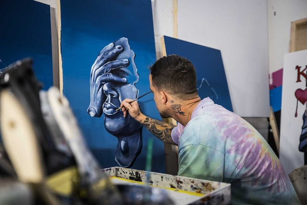Yost working on a western painting in the studio