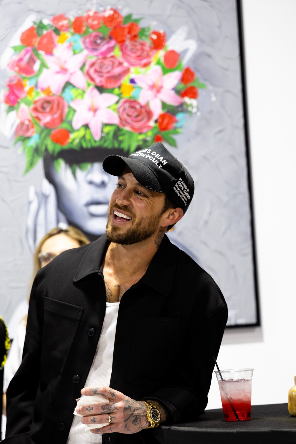 Yost standing beside a large painting in the studio